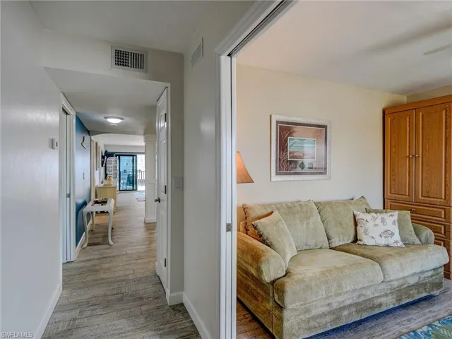 Corridor with hardwood / wood-style flooring
