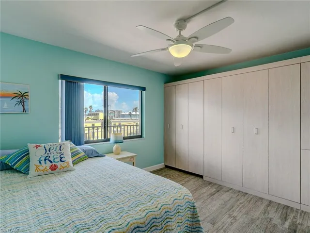 Bedroom with ceiling fan and light wood-type flooring
