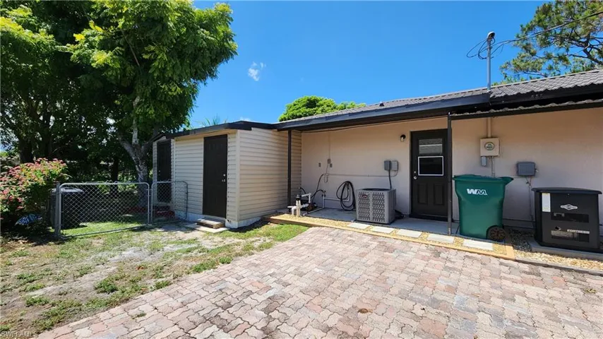 Side of home showing storage room and workshop