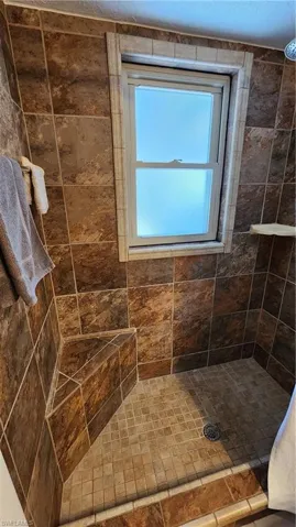 Bathroom featuring a tile shower