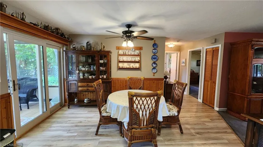 Dining space with ceiling fan and light hardwood / wood-style flooring