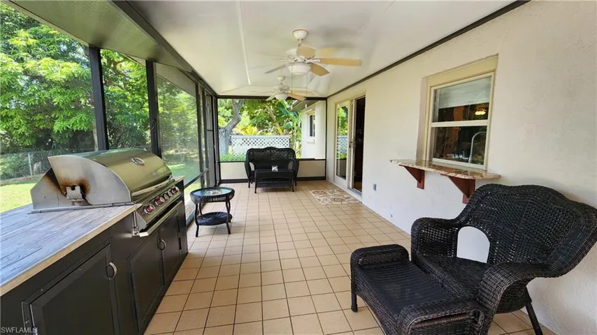 Sunroom with plenty of natural light and ceiling fan