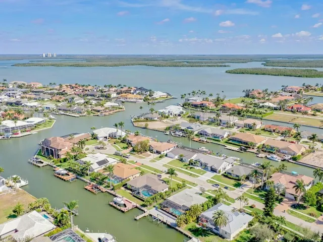 Aerial perspective of suburban area with a large body of water