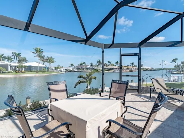 View of patio / terrace featuring a water view and a lanai