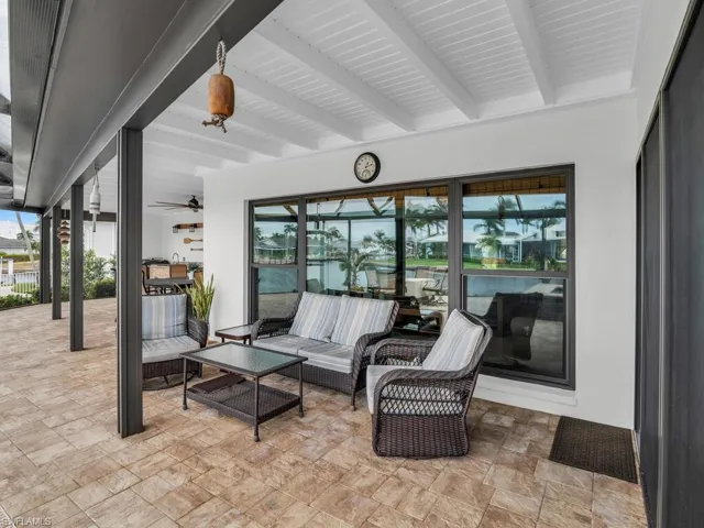 View of patio with outdoor lounge area and ceiling fan