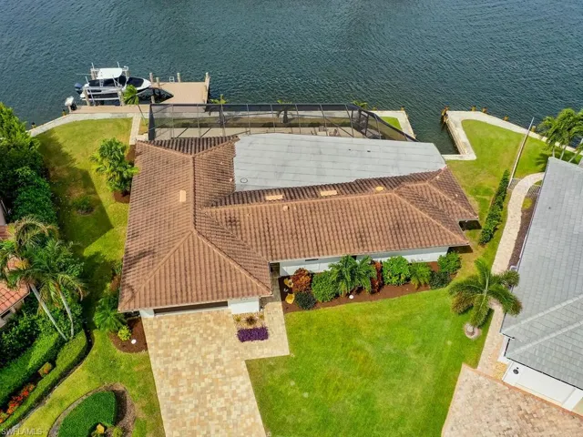 Aerial view of property and surrounding area with a nearby body of water