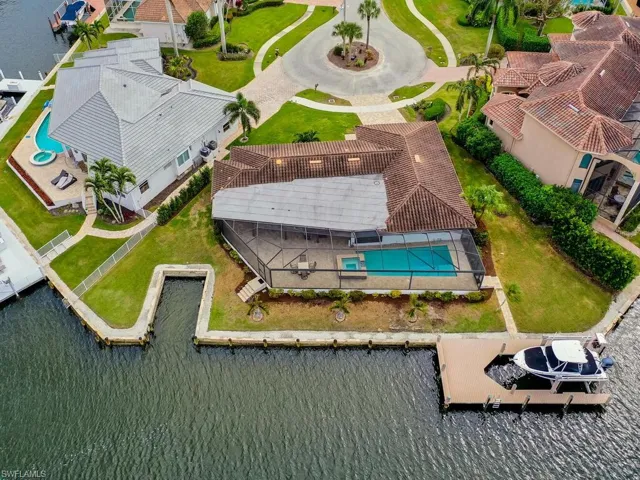 Aerial view of a pool and a large body of water
