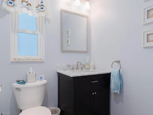 Half bathroom with vanity and toilet