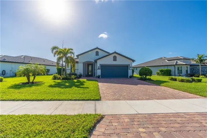 Ranch-style home with a front yard and a garage
