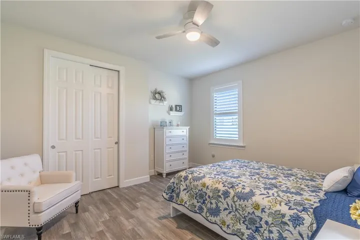 Bedroom featuring hardwood / wood-style flooring, a closet, and ceiling fan