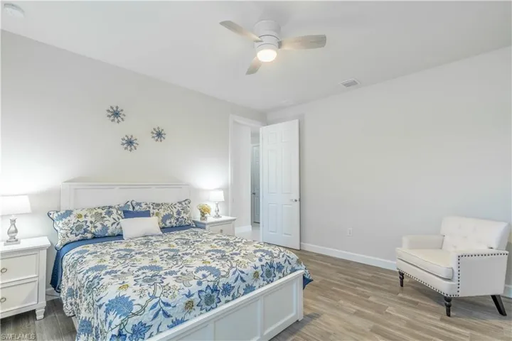 Bedroom with light hardwood / wood-style flooring and ceiling fan