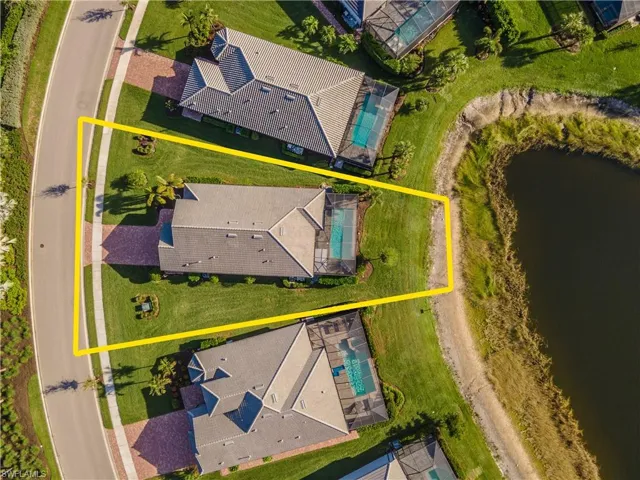 Birds eye view of property with a water view