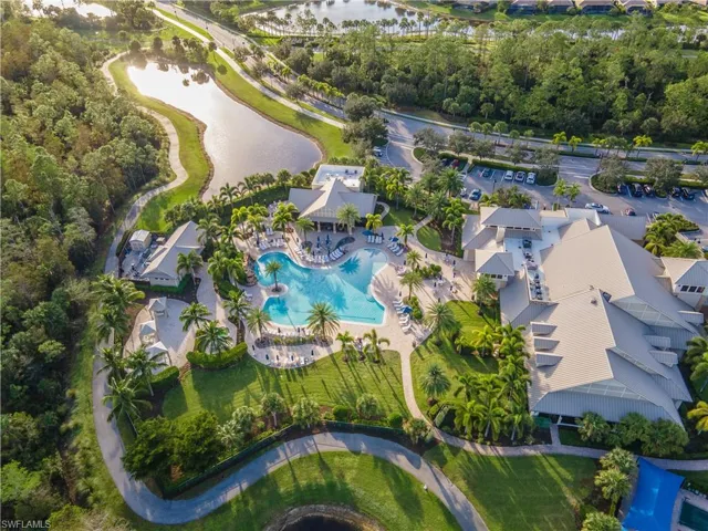 Birds eye view of property with a water view