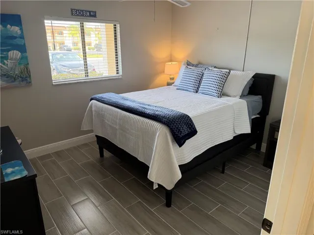 Bedroom with wood tiled floors