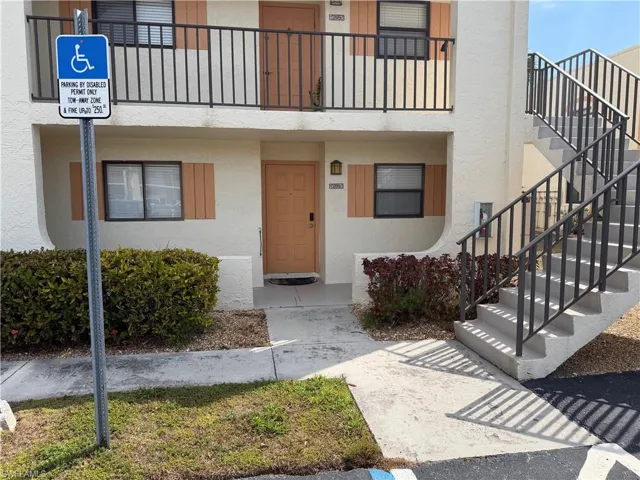 Entrance to property with stucco siding