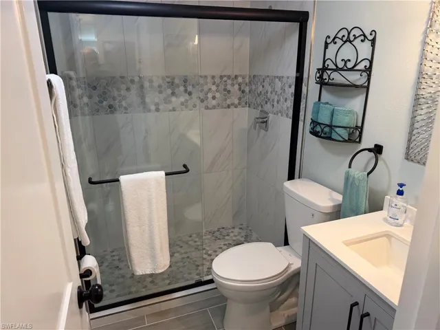 Bathroom featuring vanity and a stall shower