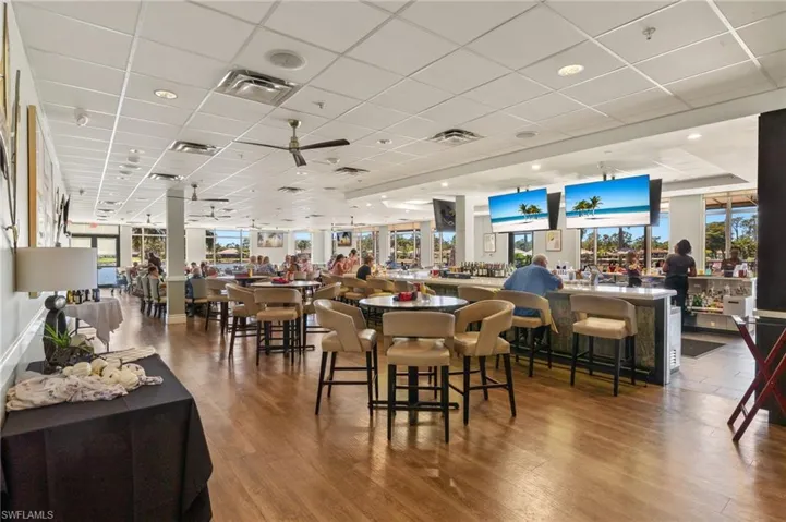 Dining area featuring a drop ceiling, visible vents, and wood finished floors