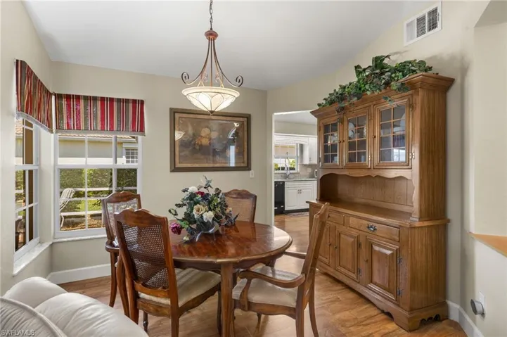 Dining space featuring visible vents, plenty of natural light, light wood-type flooring, and baseboards