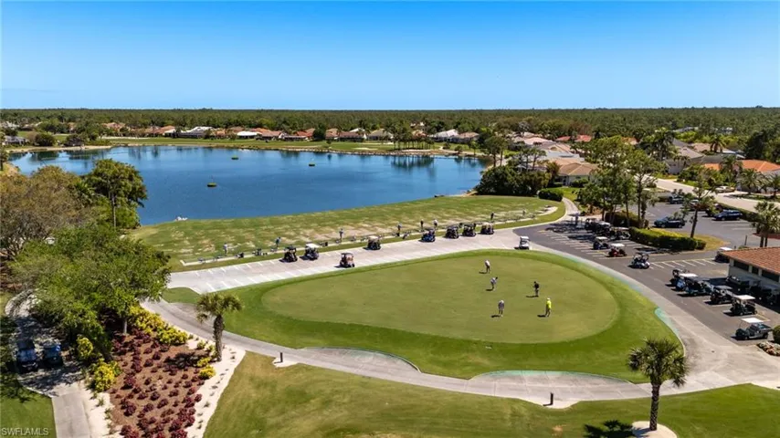 Aerial view with view of golf course and a water view
