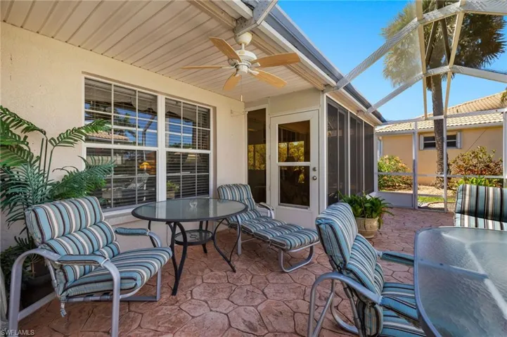 View of patio featuring a lanai and ceiling fan