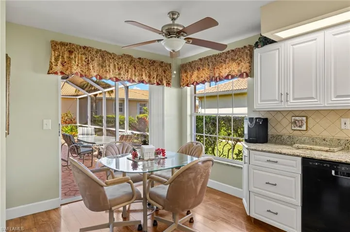 Dining room with light wood finished floors, baseboards, and a ceiling fan