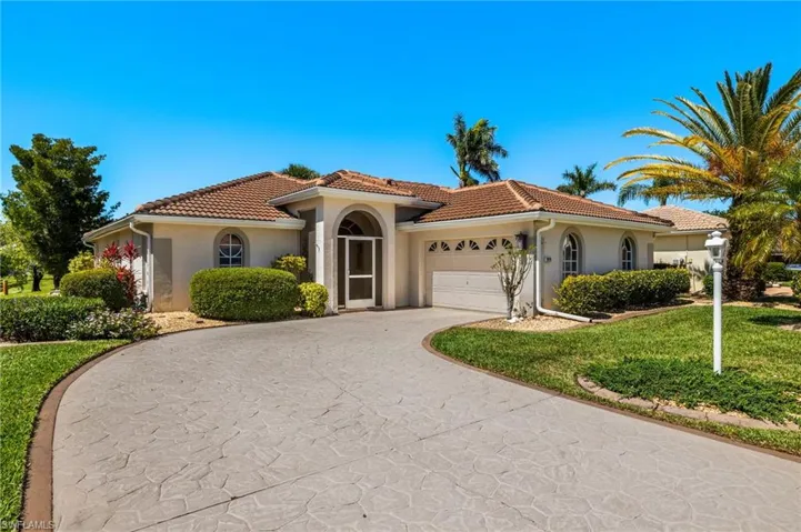 Mediterranean / spanish house featuring a tile roof, stucco siding, concrete driveway, and a garage