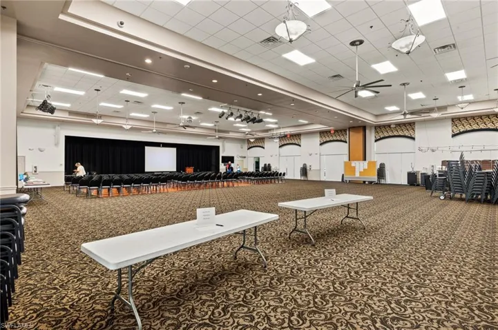Miscellaneous room featuring visible vents, carpet flooring, and a ceiling fan