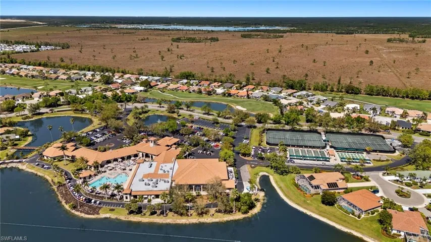 Aerial view with a residential view, a water view, and view of golf course