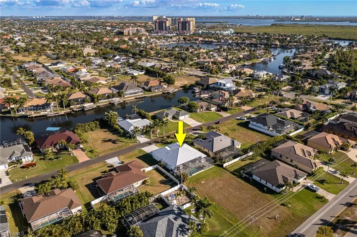 Aerial view of property's location featuring nearby suburban area and a nearby body of water