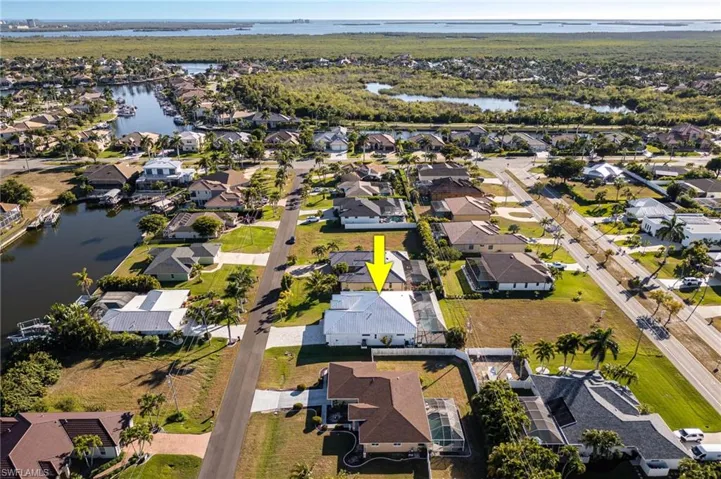 Aerial overview of property's location with nearby suburban area and a large body of water