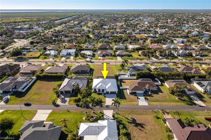 Aerial overview of property's location featuring nearby suburban area