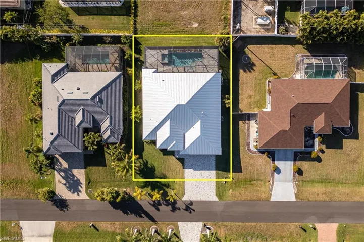 Aerial view of residential area featuring property boundaries highlighted