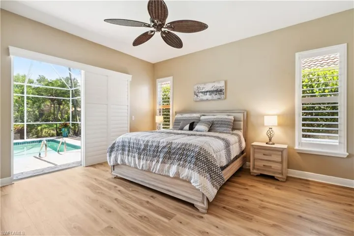Bedroom with ceiling fan, light wood-type flooring, and access to exterior