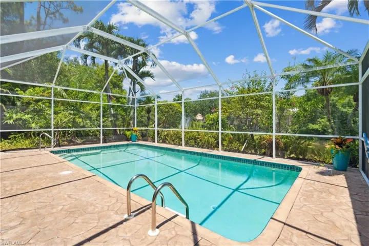 View of swimming pool featuring a patio and a lanai