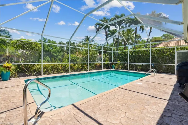 View of pool with a patio and a lanai