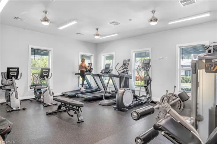 Exercise room with a wealth of natural light and ceiling fan