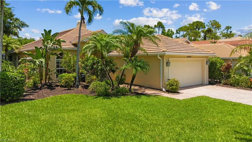 Mediterranean / spanish-style house featuring a front yard and a garage