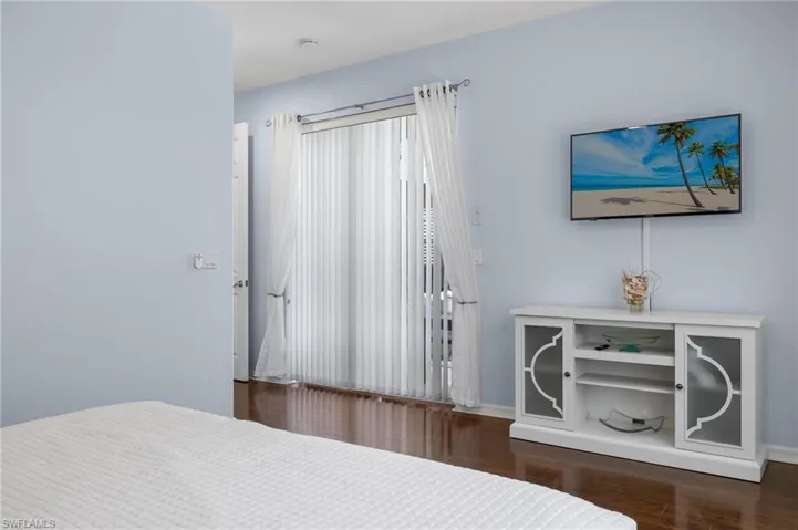 Bedroom with dark hardwood / wood-style floors