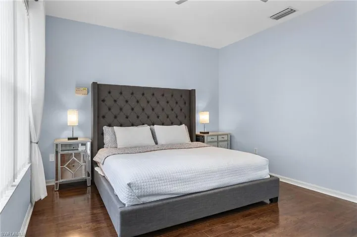 Bedroom with dark wood-type flooring