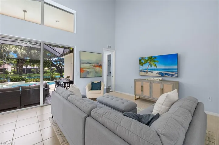 Tiled living room featuring a towering ceiling