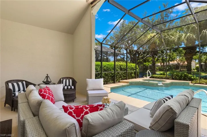 View of swimming pool featuring a patio, outdoor lounge area, a lanai, and an in ground hot tub