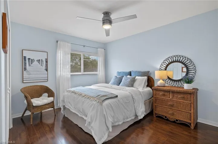 Bedroom featuring ceiling fan and wood-type flooring