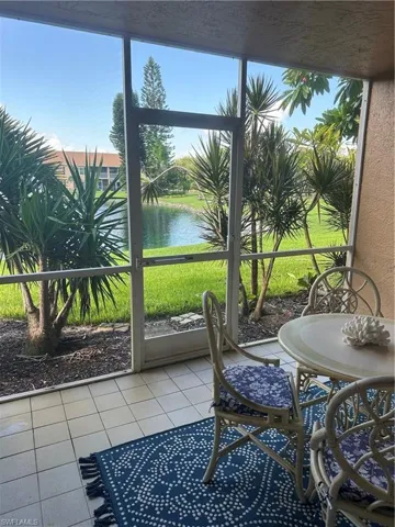 Sunroom featuring a water view and fountain
