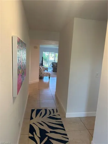 Hall featuring light tile patterned floors