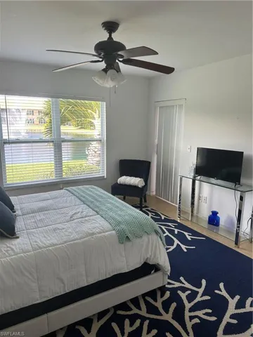 Bedroom featuring wood-type flooring and ceiling fan