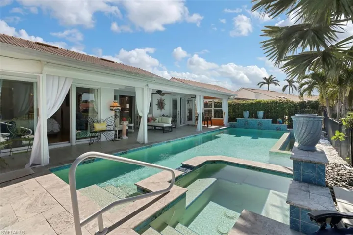 View of swimming pool featuring an in ground hot tub, outdoor lounge area, a patio, and ceiling fan