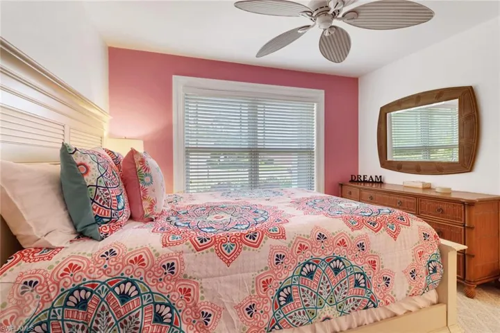 Bedroom with light carpet and ceiling fan