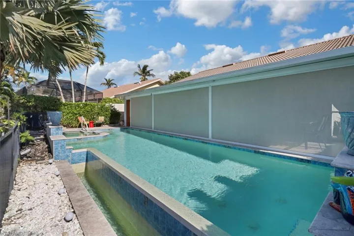 View of swimming pool with an in ground hot tub