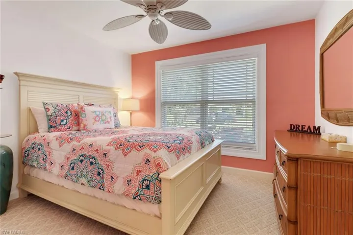 Carpeted bedroom featuring ceiling fan