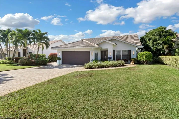 Mediterranean / spanish house with a garage and a front lawn